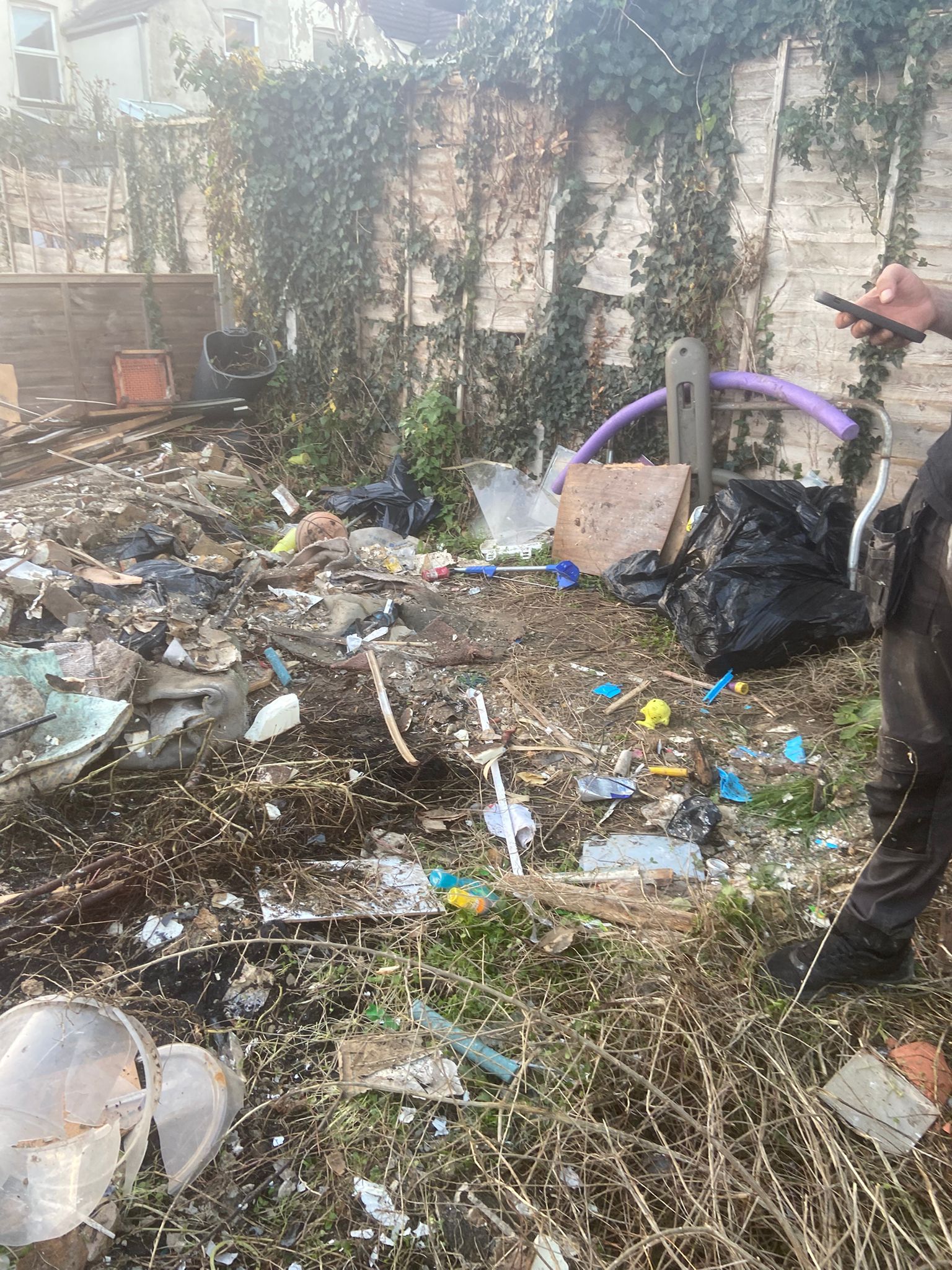 Medway Rubbish Removal team on site clearing a garden of debris and black bags