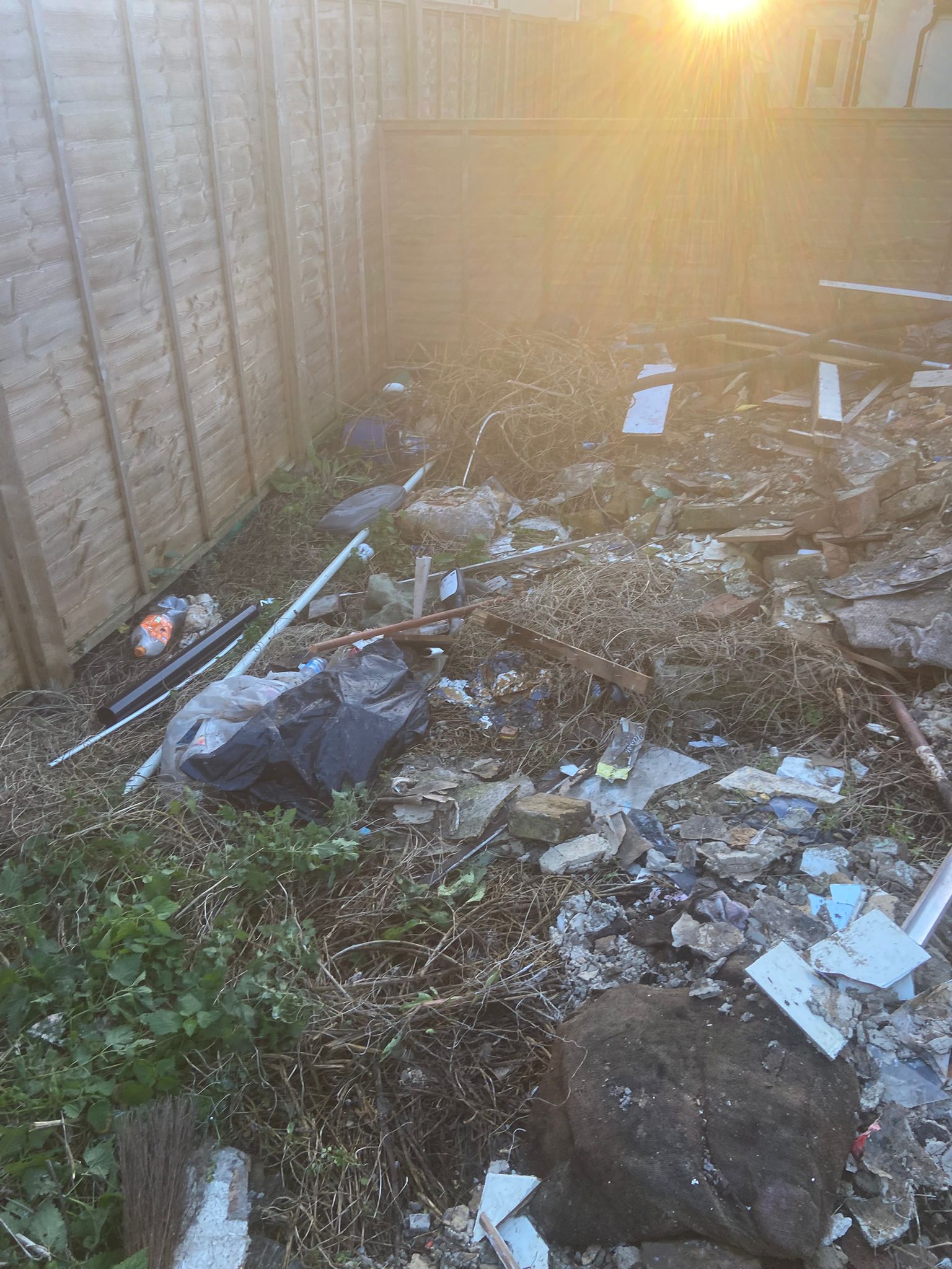 Overgrown Medway back garden packed with rubbish before our clearance team arrived